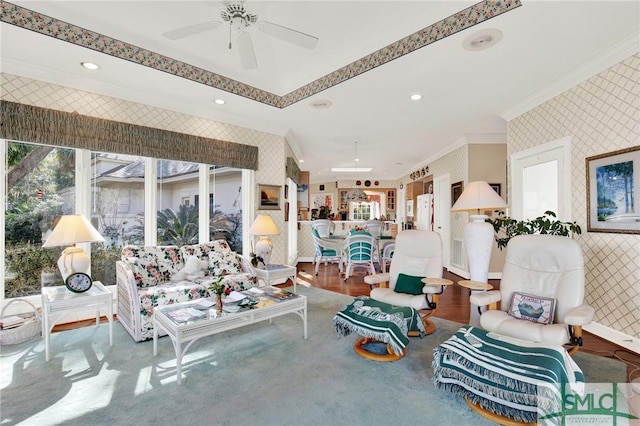 living room with crown molding, ceiling fan, and wood-type flooring