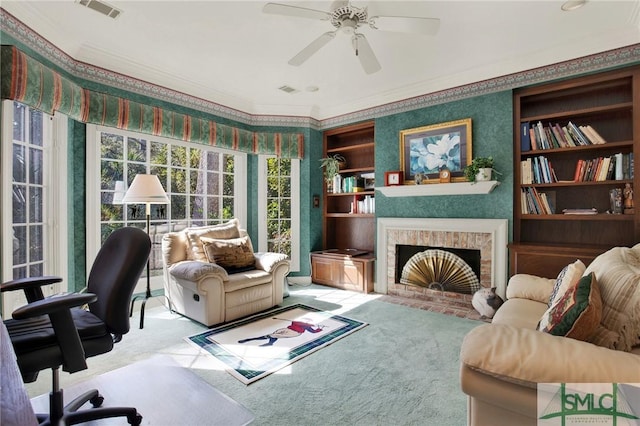 office with ornamental molding, carpet floors, ceiling fan, and a fireplace