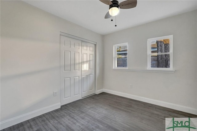 unfurnished bedroom with a closet, dark hardwood / wood-style floors, and ceiling fan