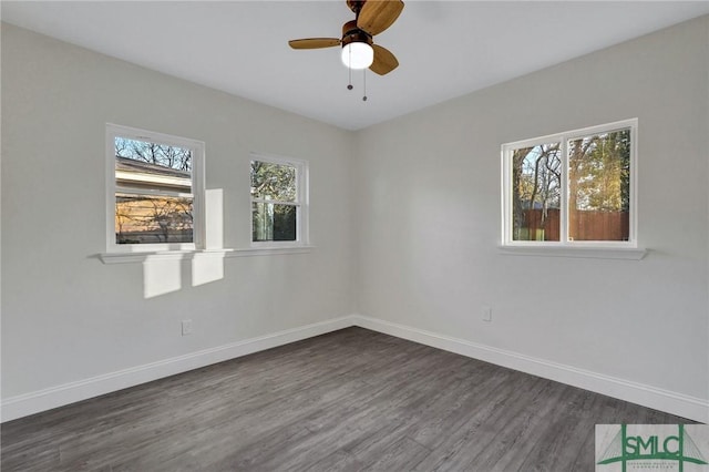 spare room with dark hardwood / wood-style floors and ceiling fan