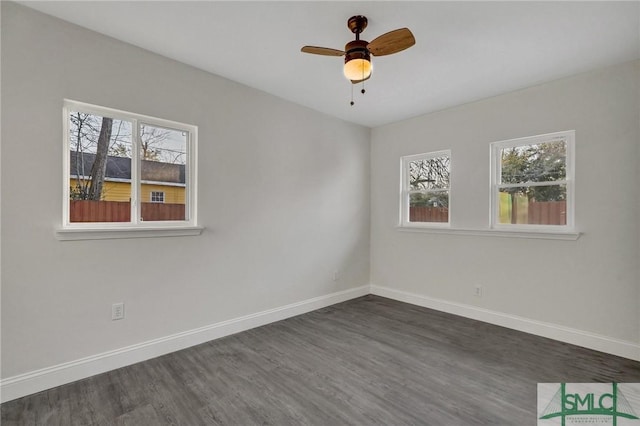 unfurnished room featuring ceiling fan, dark hardwood / wood-style floors, and a healthy amount of sunlight