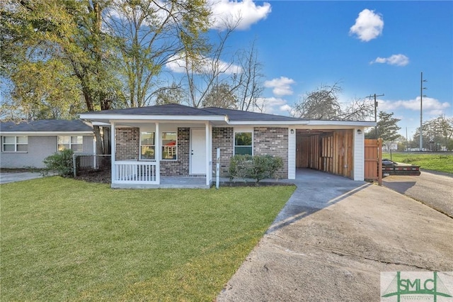 single story home with a front yard, a carport, and covered porch