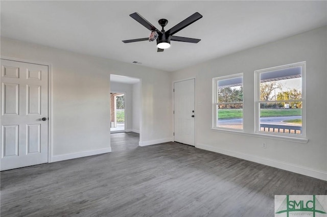 spare room featuring ceiling fan and dark hardwood / wood-style flooring