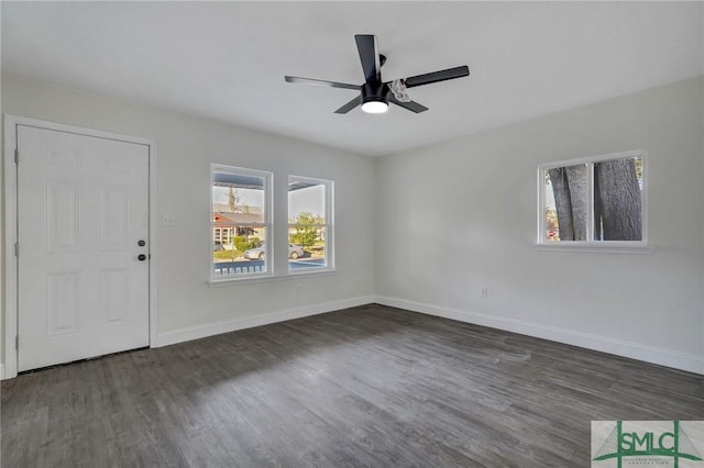 interior space with dark wood-type flooring and ceiling fan