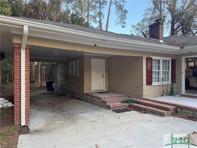 entrance to property featuring a carport