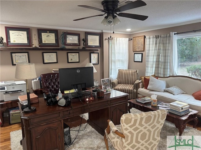 home office with crown molding, a textured ceiling, ceiling fan, and light wood-type flooring