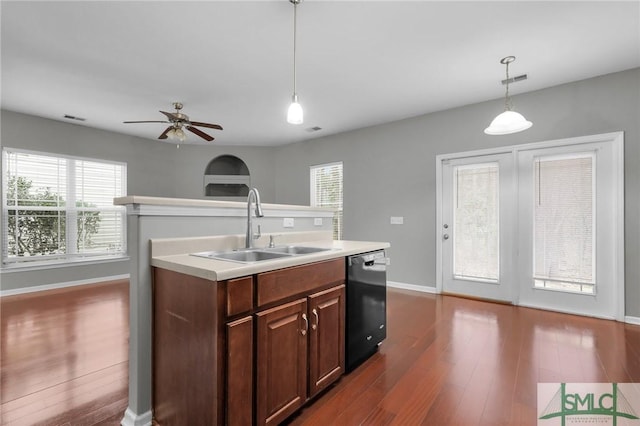 kitchen with dishwasher, sink, pendant lighting, and a kitchen island with sink