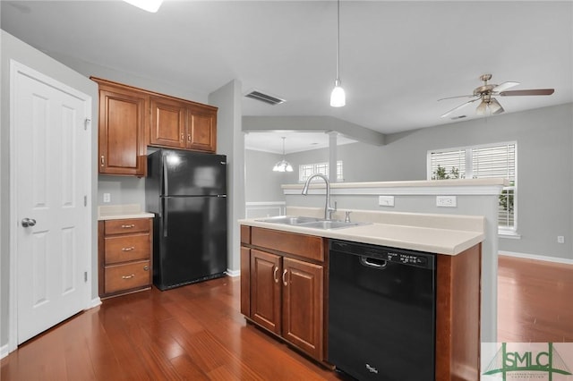 kitchen with dark wood-type flooring, sink, hanging light fixtures, ceiling fan, and black appliances