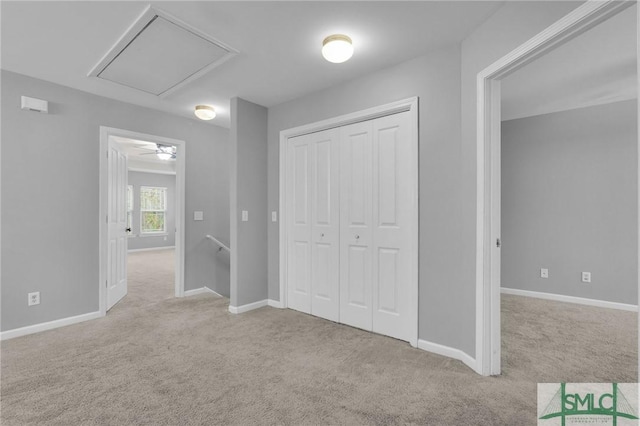 unfurnished bedroom with a closet and light carpet