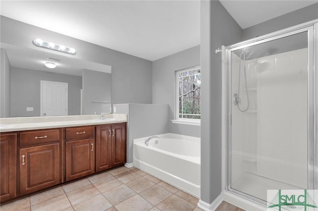 bathroom featuring tile patterned floors, separate shower and tub, and vanity