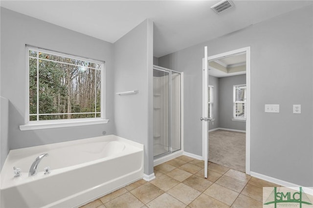 bathroom with tile patterned floors, plus walk in shower, and a tray ceiling