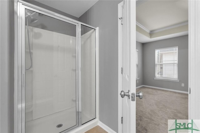 bathroom with crown molding and an enclosed shower