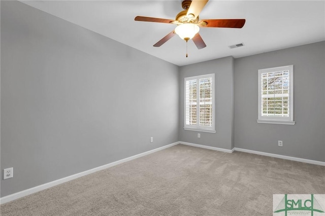 carpeted spare room with ceiling fan