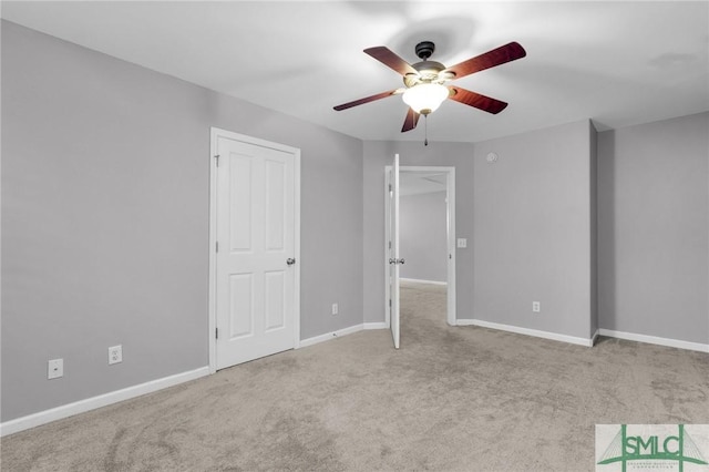 unfurnished bedroom with ceiling fan and light carpet