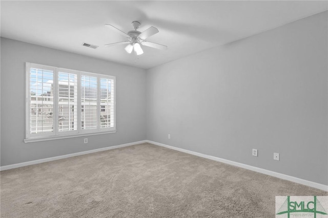 carpeted spare room with ceiling fan