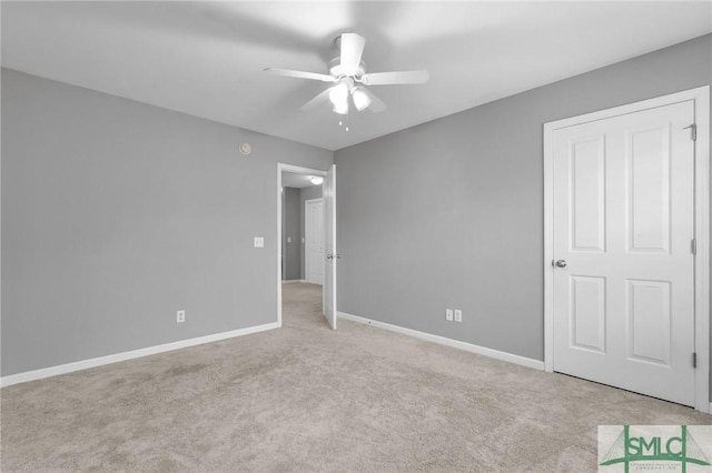 unfurnished bedroom with light colored carpet and ceiling fan