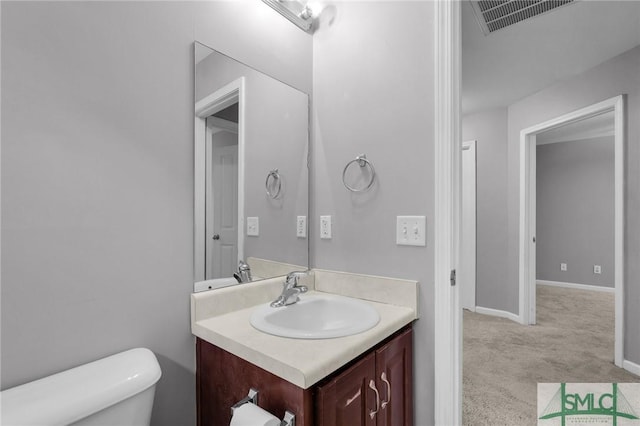 bathroom featuring vanity and toilet