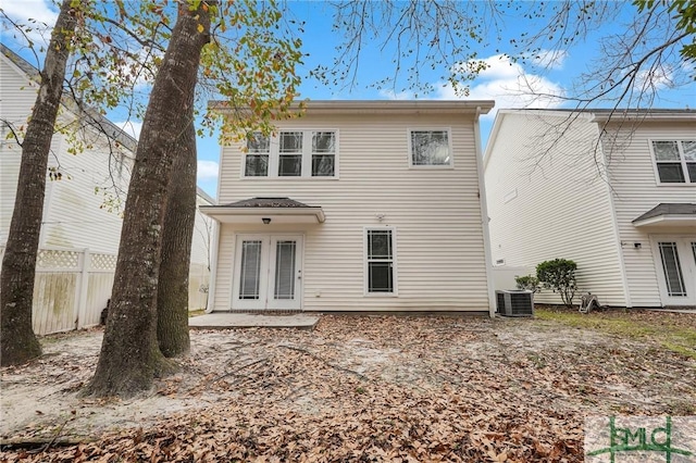 back of house with central AC unit