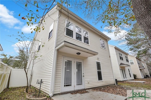 rear view of house featuring french doors