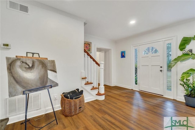 entryway with crown molding and dark wood-type flooring