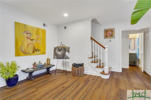 interior space with hardwood / wood-style floors and ornamental molding