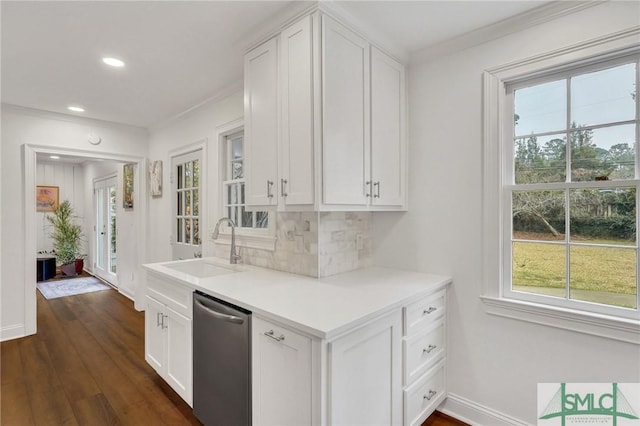 kitchen with white cabinets, backsplash, sink, and dishwasher