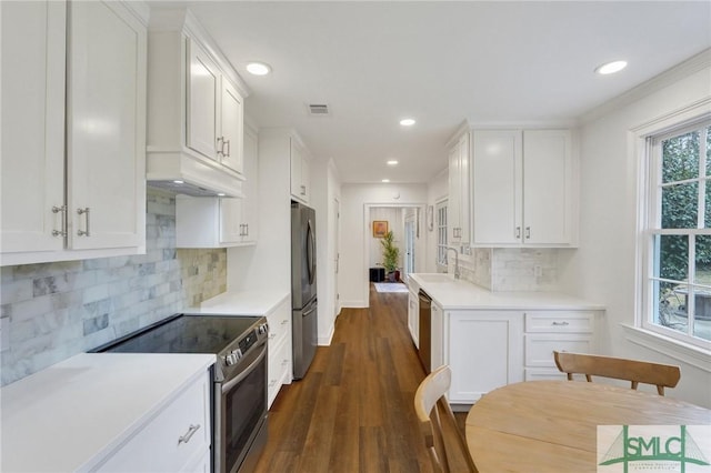 kitchen with appliances with stainless steel finishes, sink, and white cabinets