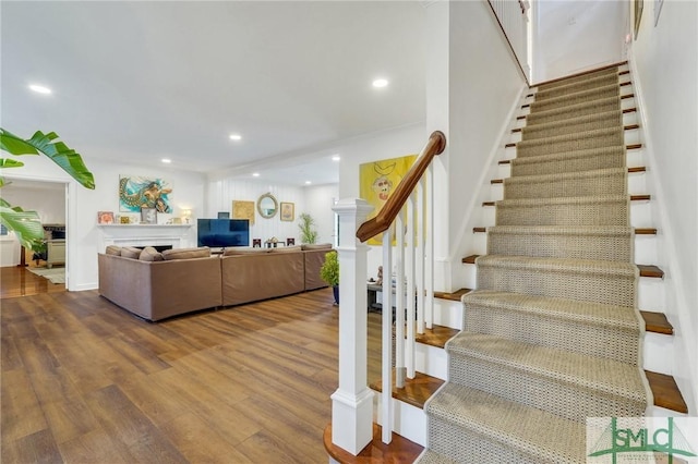 stairway with hardwood / wood-style floors