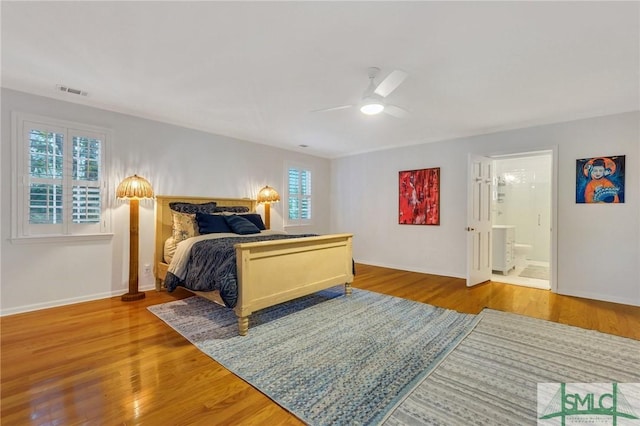 bedroom with ensuite bathroom, ceiling fan, and light wood-type flooring