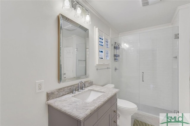 bathroom with vanity, crown molding, a shower with door, and toilet