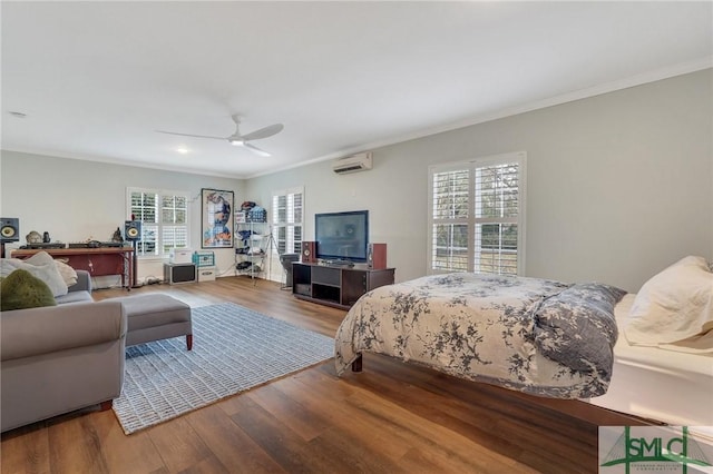 bedroom with ornamental molding, hardwood / wood-style floors, and an AC wall unit