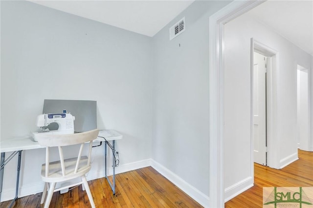 home office with hardwood / wood-style floors