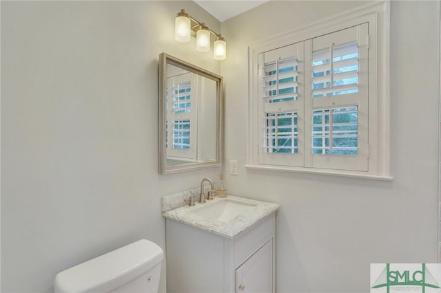 bathroom featuring vanity and toilet