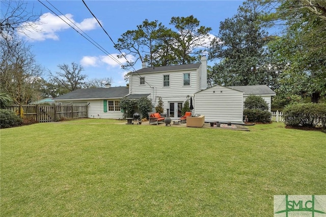 rear view of property featuring a yard and a patio