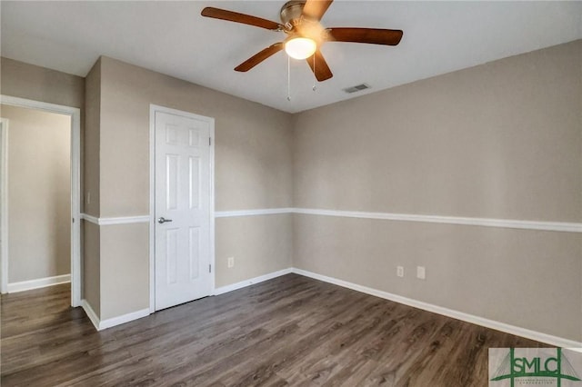 unfurnished room featuring dark hardwood / wood-style floors and ceiling fan