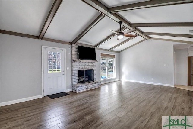 unfurnished living room with ceiling fan, vaulted ceiling with beams, hardwood / wood-style floors, and a fireplace