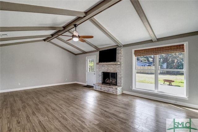 unfurnished living room featuring vaulted ceiling with beams, a fireplace, dark hardwood / wood-style floors, and ceiling fan