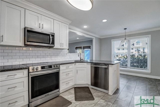 kitchen with white cabinetry, sink, ornamental molding, and appliances with stainless steel finishes