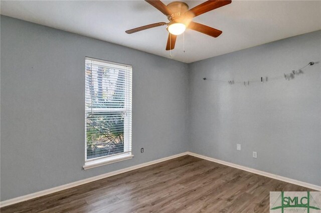 unfurnished room featuring dark hardwood / wood-style floors and ceiling fan