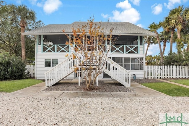 rear view of property featuring a sunroom