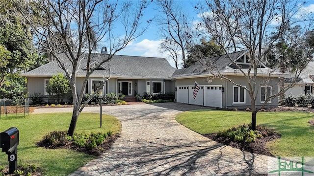 ranch-style home featuring a garage and a front lawn