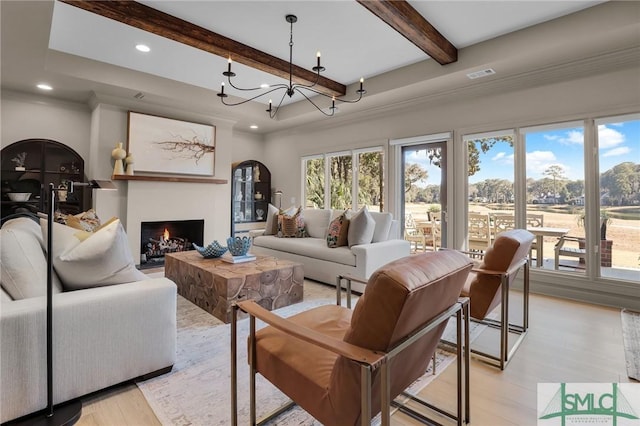 living room with crown molding, beam ceiling, a chandelier, and light wood-type flooring