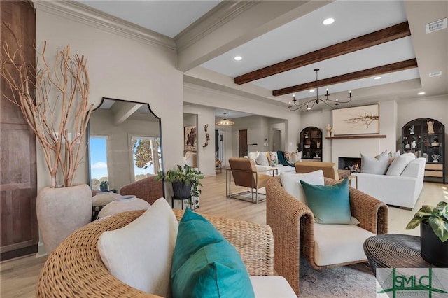 living room featuring beamed ceiling, ornamental molding, and light hardwood / wood-style floors