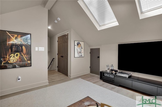 living room with vaulted ceiling with skylight and light wood-type flooring