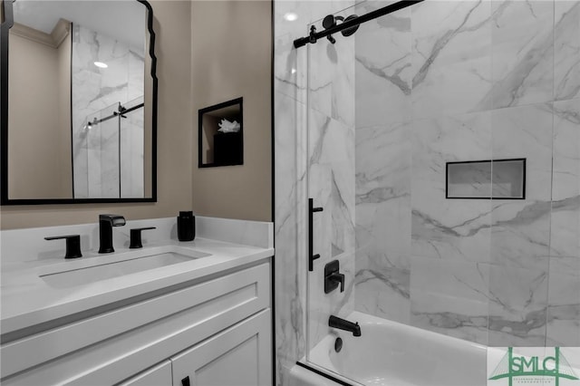 bathroom featuring tiled shower / bath combo and vanity