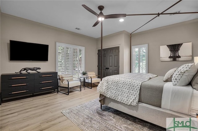 bedroom featuring ornamental molding, ceiling fan, and light hardwood / wood-style floors