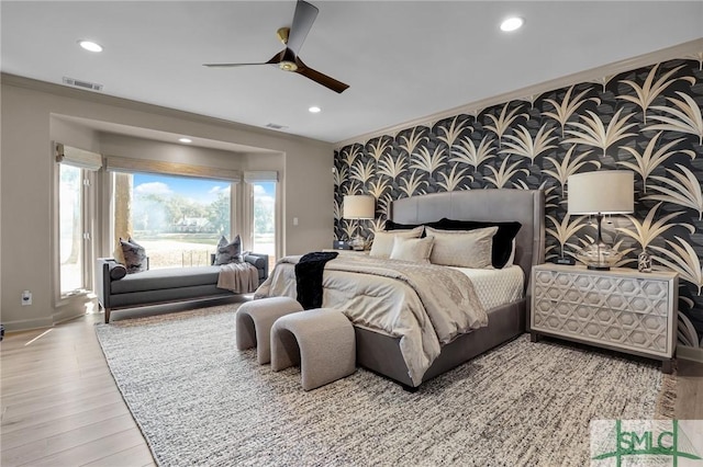 bedroom featuring ceiling fan, ornamental molding, light wood-type flooring, and access to outside