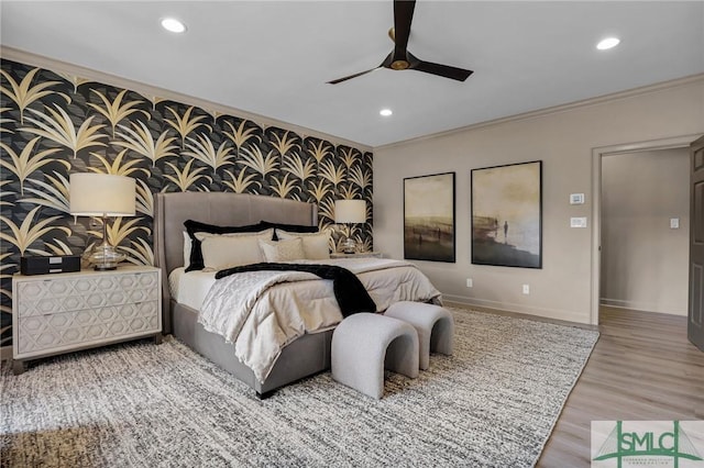 bedroom featuring hardwood / wood-style flooring, ornamental molding, and ceiling fan