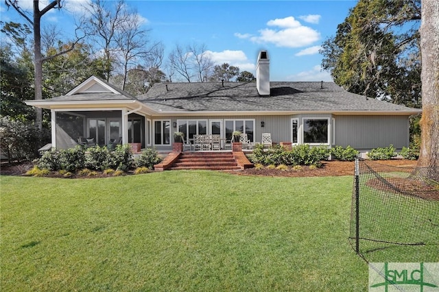 back of property featuring a sunroom and a lawn