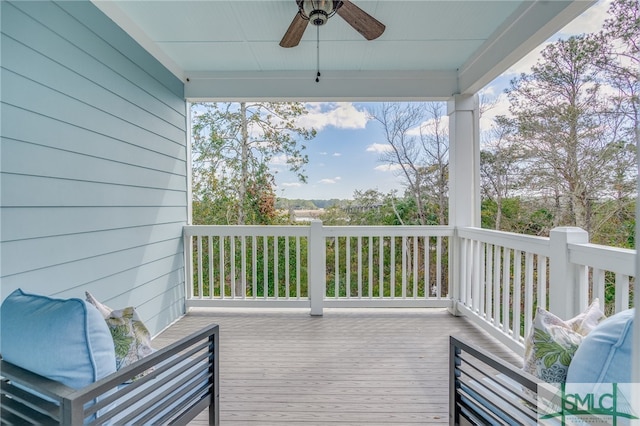 wooden deck featuring ceiling fan